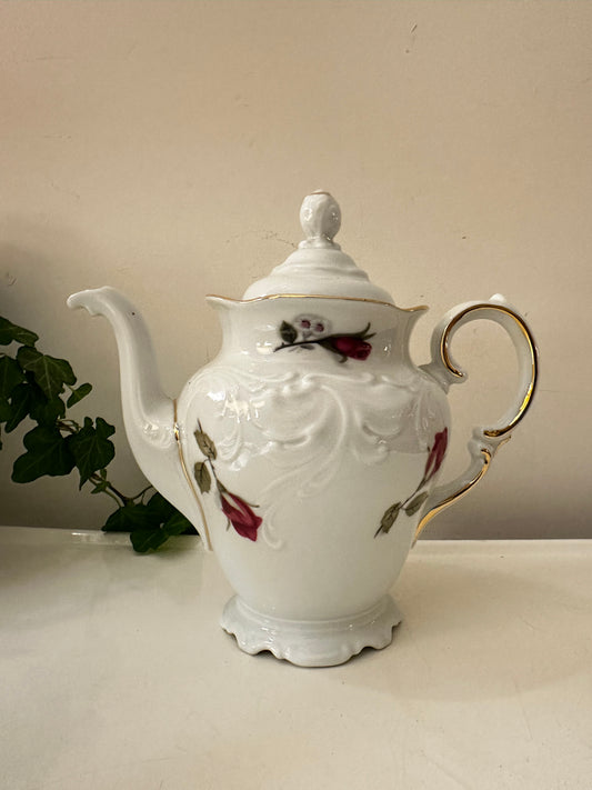 Porseleinen theepot met rozenprint